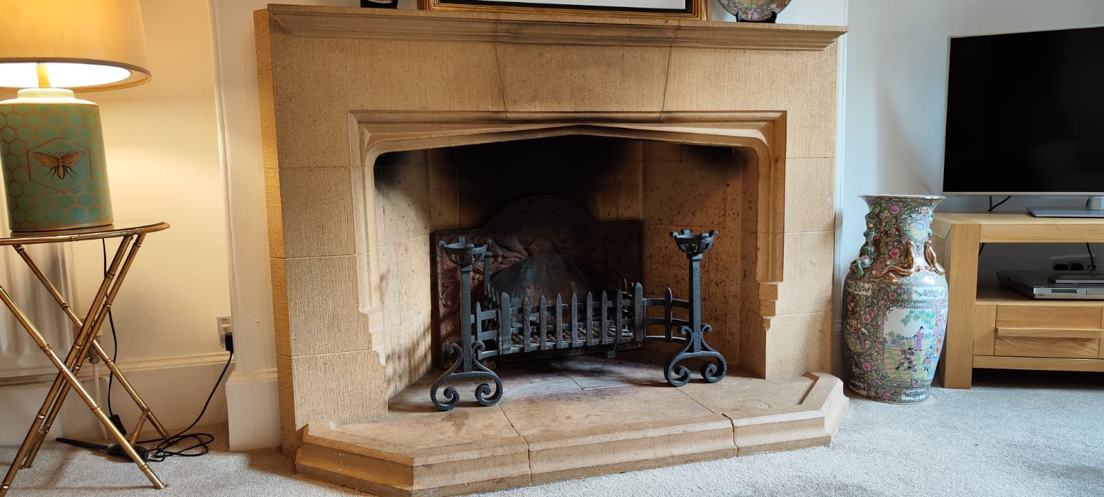 Stove Servicing and Minor Repairs: What to Ask Open fireplace with a fire basket and stone surround