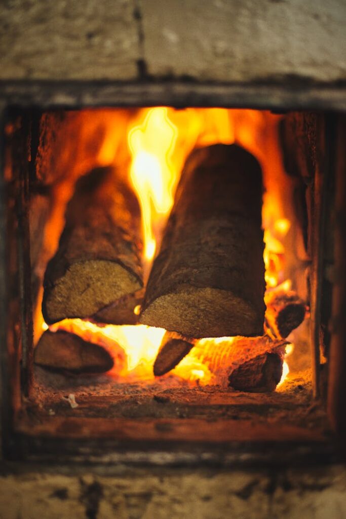 Close-up of firewood burning in a fireplace, creating a warm, cozy atmosphere.